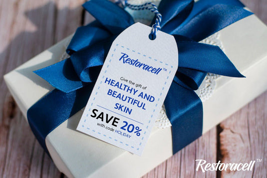 A giftbox with tag reading "Restoracell, Give the gift of healthy and beautiful skin, Save 20% with code."