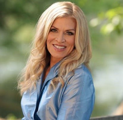 A woman with smooth, bright skin smiling into the camera.