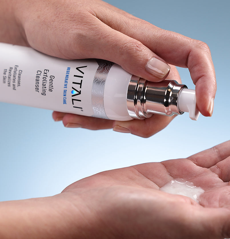 A bottle of Vitali's gentle exfoliating cleanser being pumped into someone's hands.