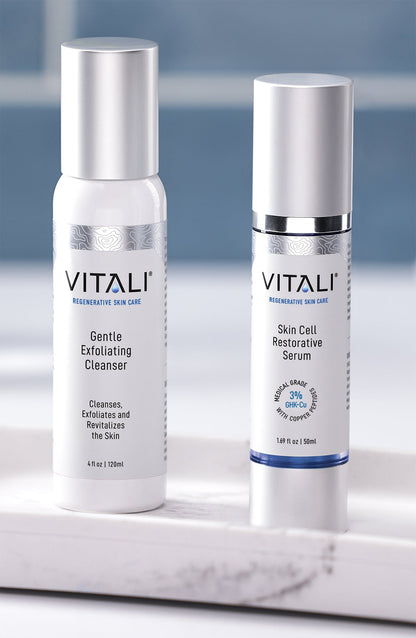 Two small skincare bottles, one a gentle exfoliating cleanser and one a skin cell restorative serum.